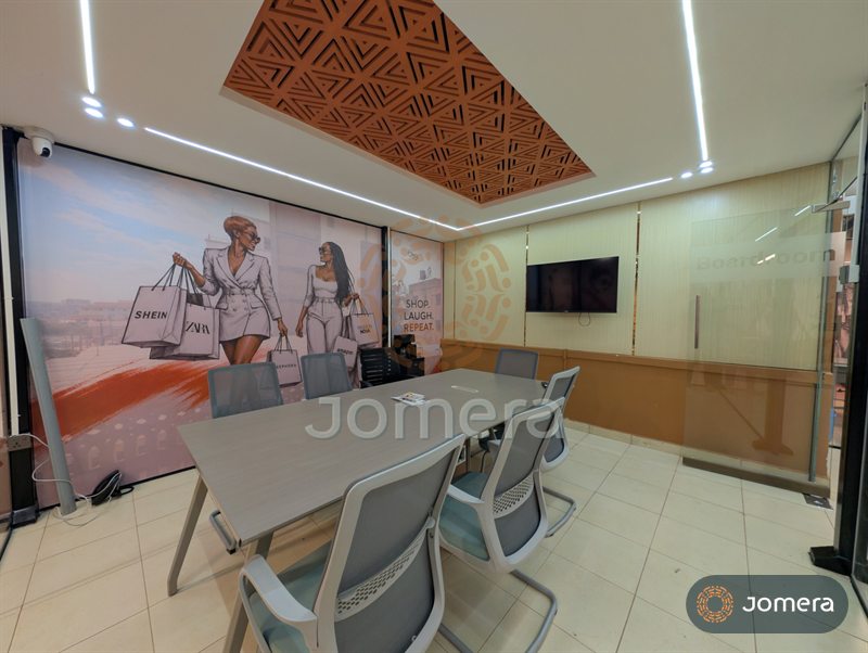 Boardroom with a long grey table, mesh chairs, a timber-panelled TV wall and a CNC-cut ceiling feature